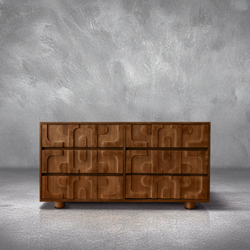 Funky Dresser in warm mango wood with sculptural 3D carved drawer fronts and cylindrical feet, in a bedroom