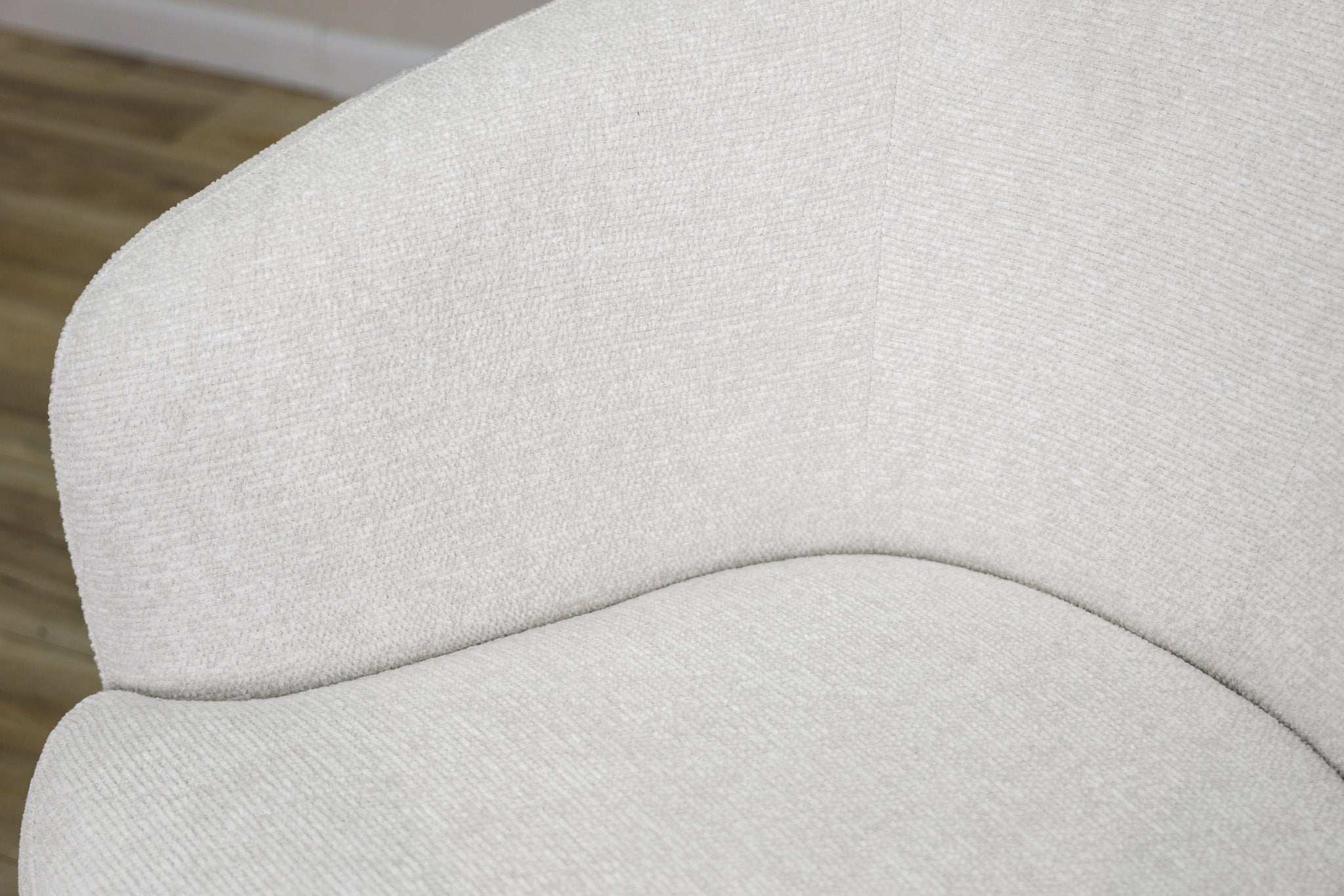 London Swivel Chair in white performance fabric with a curved barrel body on a dark wood swivel base, living room