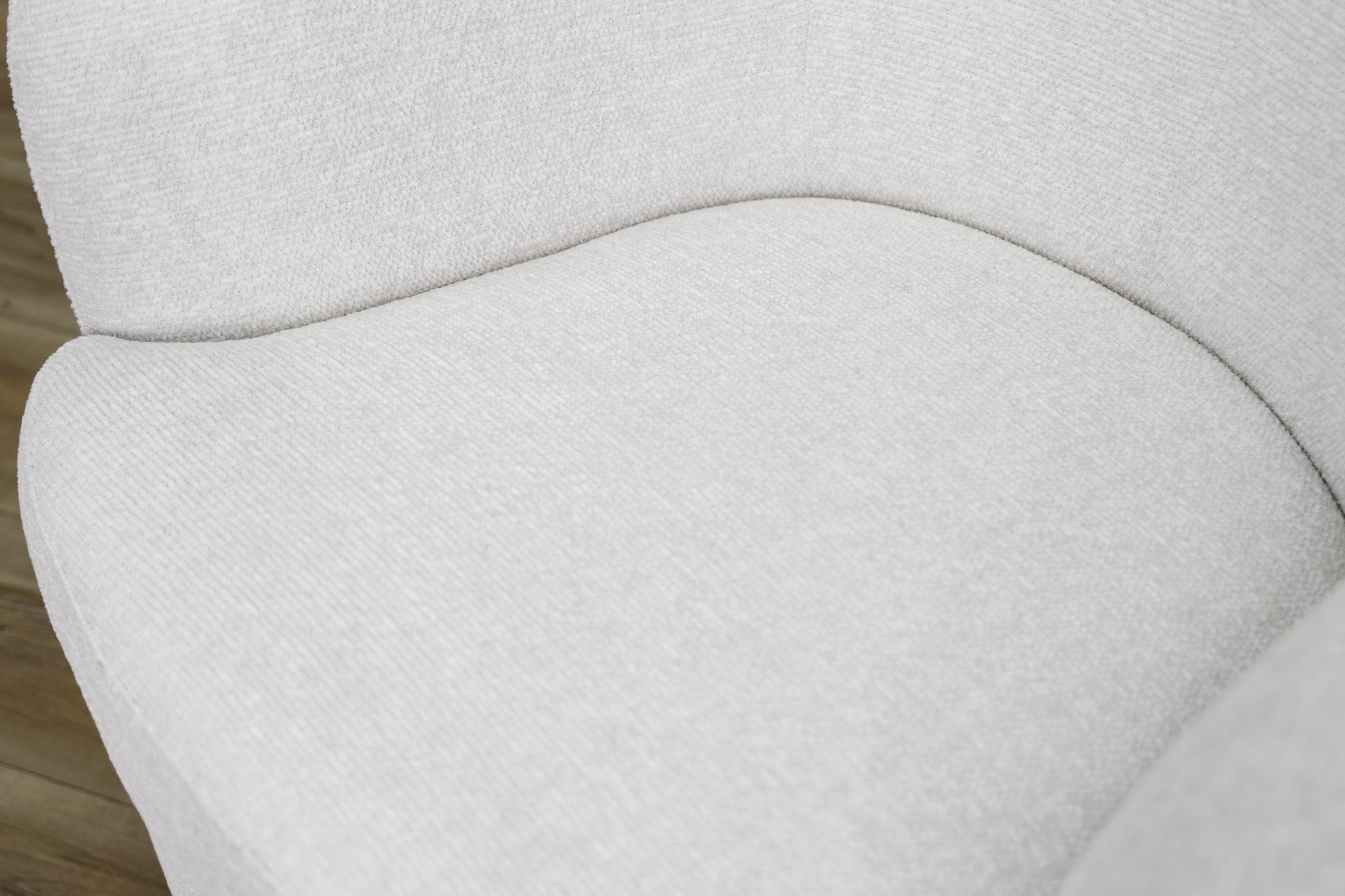 London Swivel Chair in white performance fabric with a curved barrel body on a dark wood swivel base, living room