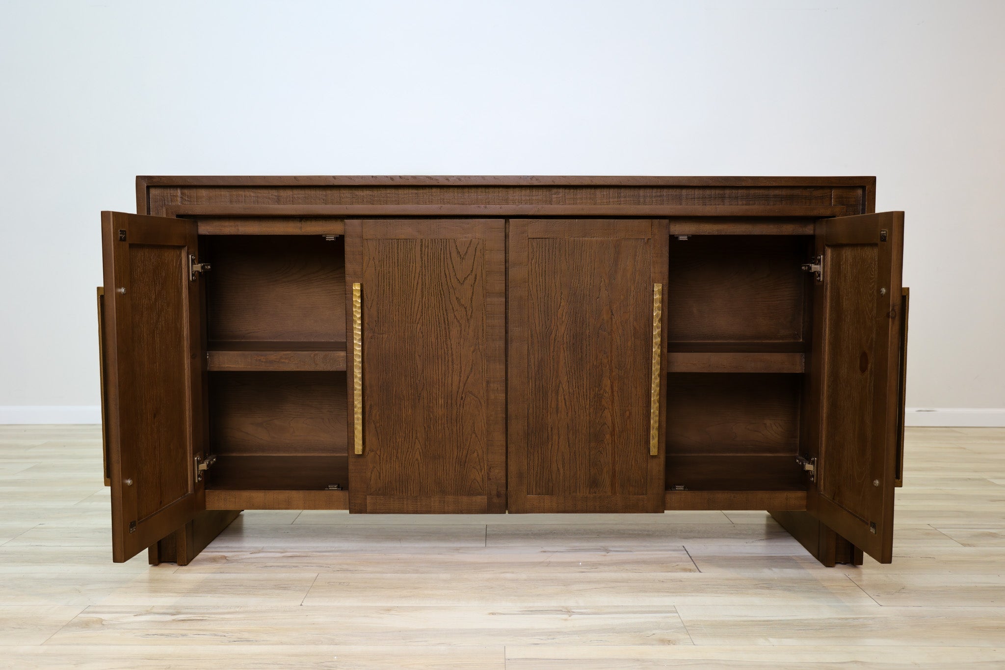 Manny 67-inch credenza in solid Mexican pine with four doors and hammered gold bar handles, living room