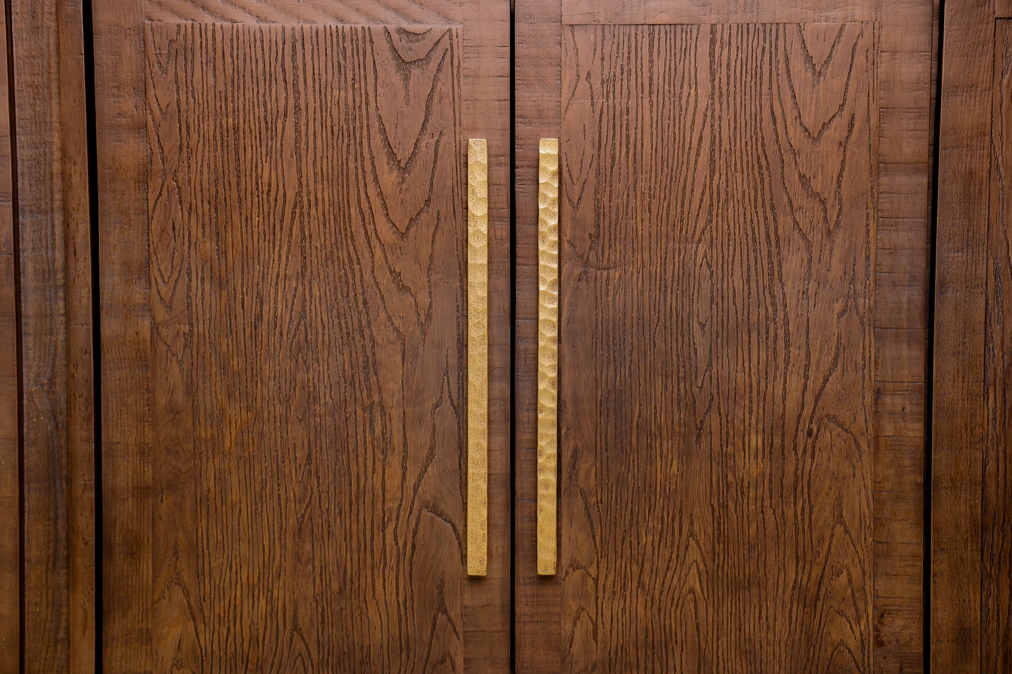 Manny 67-inch credenza in solid Mexican pine with four doors and hammered gold bar handles, living room