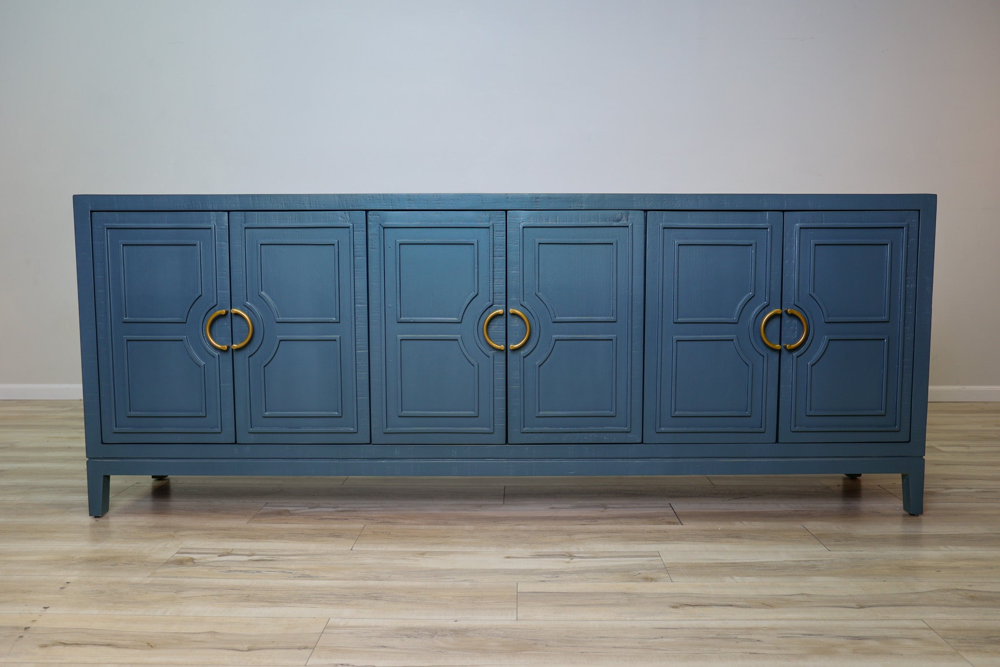 David 90-inch blue credenza in solid Mexican pine with six geometric panel doors and gold ring pulls, living room