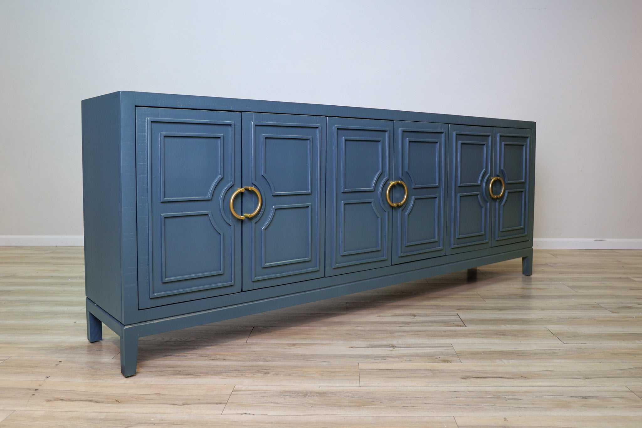 David 90-inch blue credenza in solid Mexican pine with six geometric panel doors and gold ring pulls, living room
