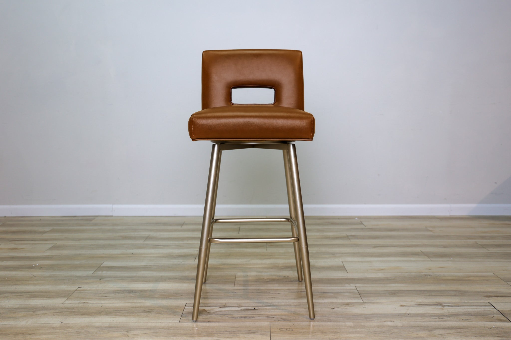 Versa Keyback adjustable barstool in cognac faux leather with a keyhole back and gold metal swivel base, kitchen bar