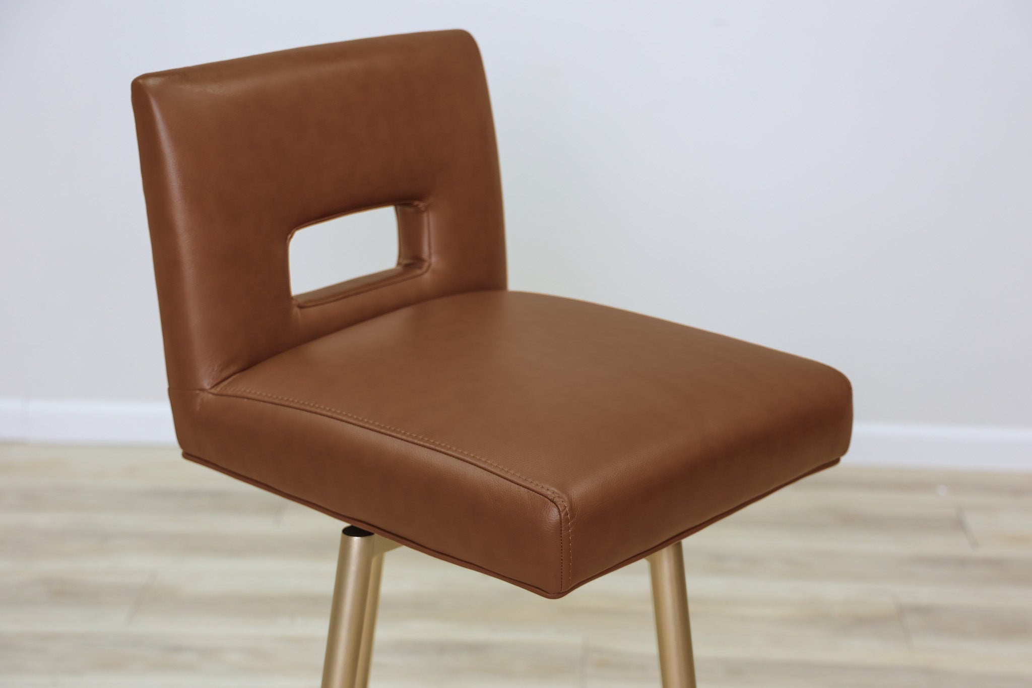 Versa Keyback adjustable barstool in cognac faux leather with a keyhole back and gold metal swivel base, kitchen bar
