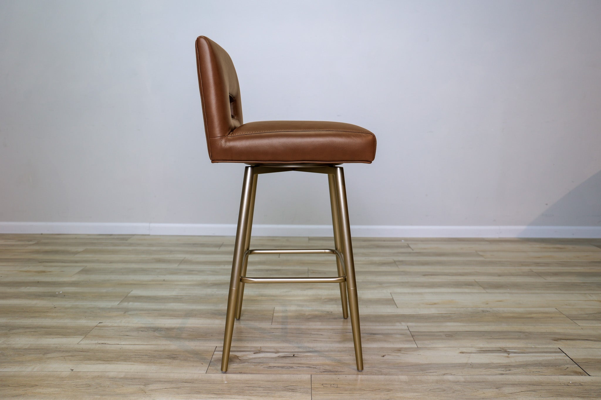Versa Keyback adjustable barstool in cognac faux leather with a keyhole back and gold metal swivel base, kitchen bar