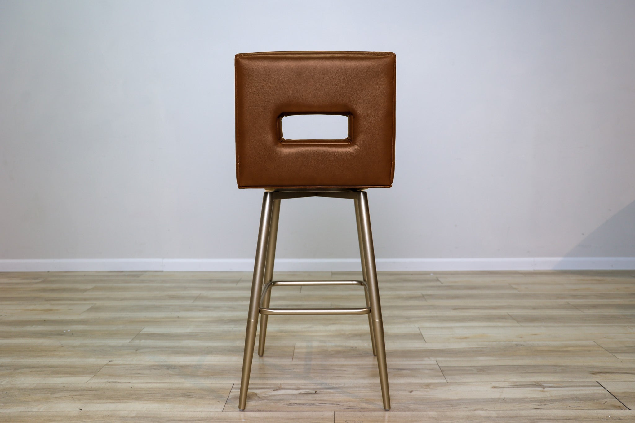 Versa Keyback adjustable barstool in cognac faux leather with a keyhole back and gold metal swivel base, kitchen bar