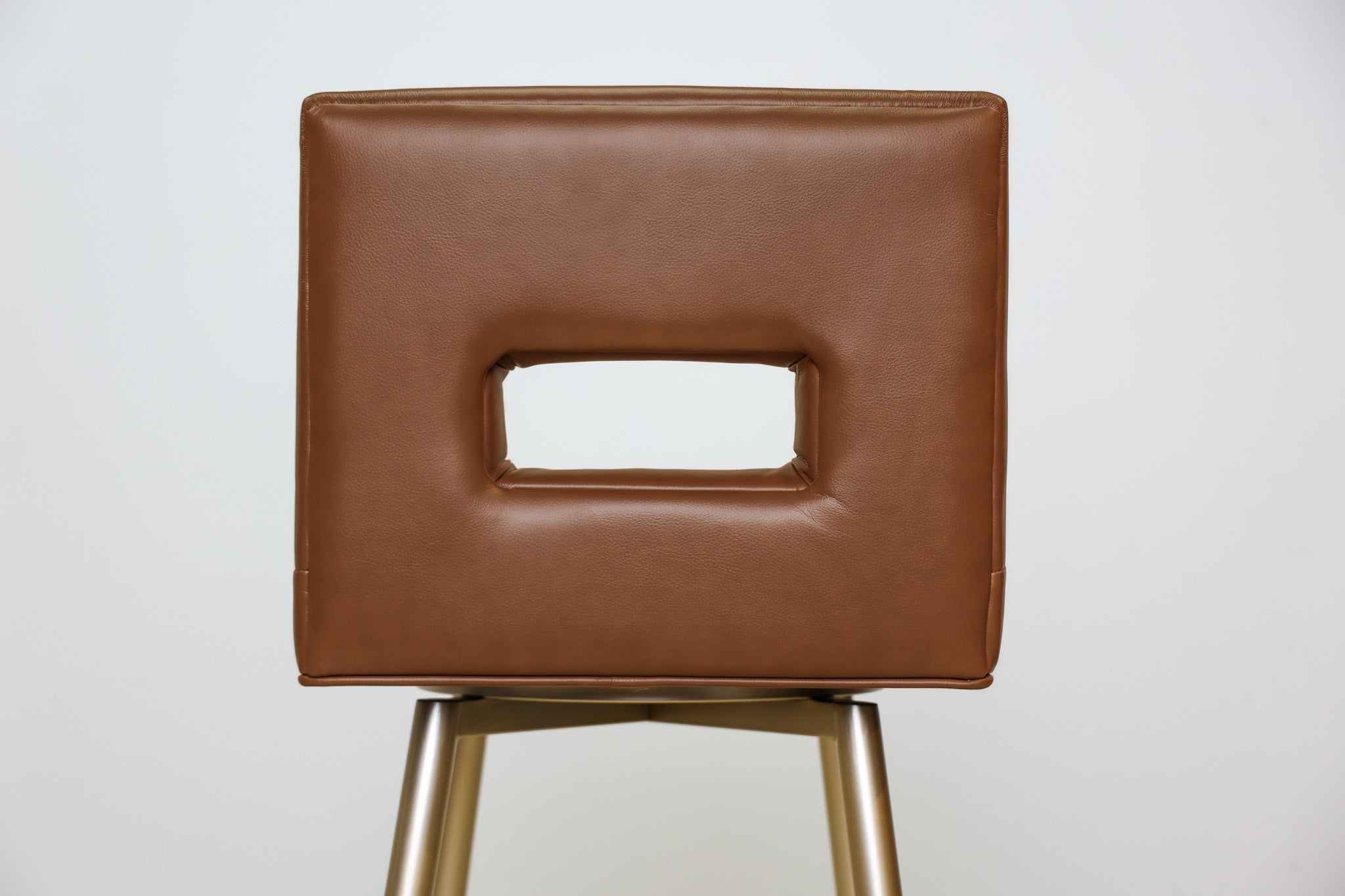 Versa Keyback adjustable barstool in cognac faux leather with a keyhole back and gold metal swivel base, kitchen bar