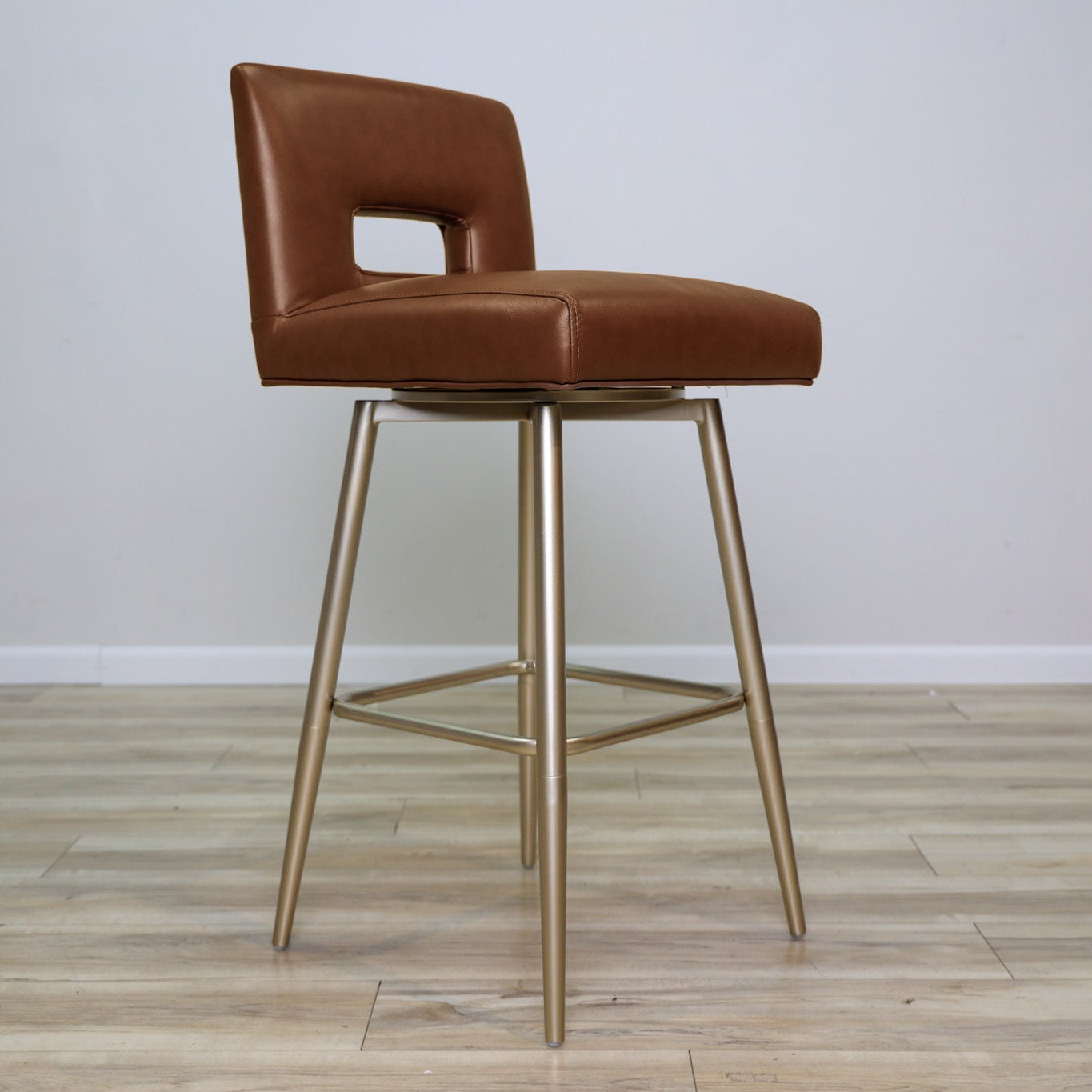 Versa Keyback adjustable barstool in cognac faux leather with a keyhole back and gold metal swivel base, kitchen bar