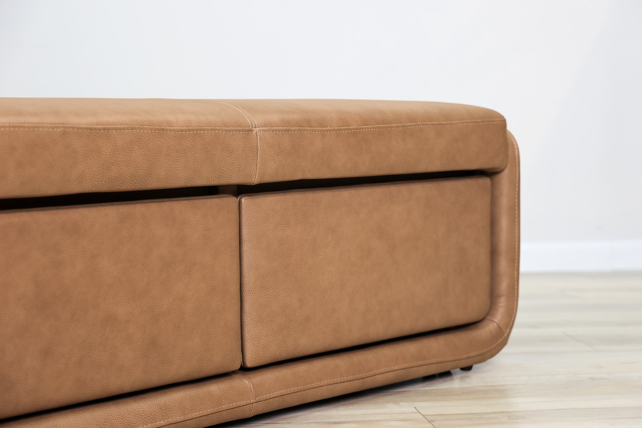 Gomez storage bench in brown top-grain leather with two pull-out drawers and a cushioned top, living room