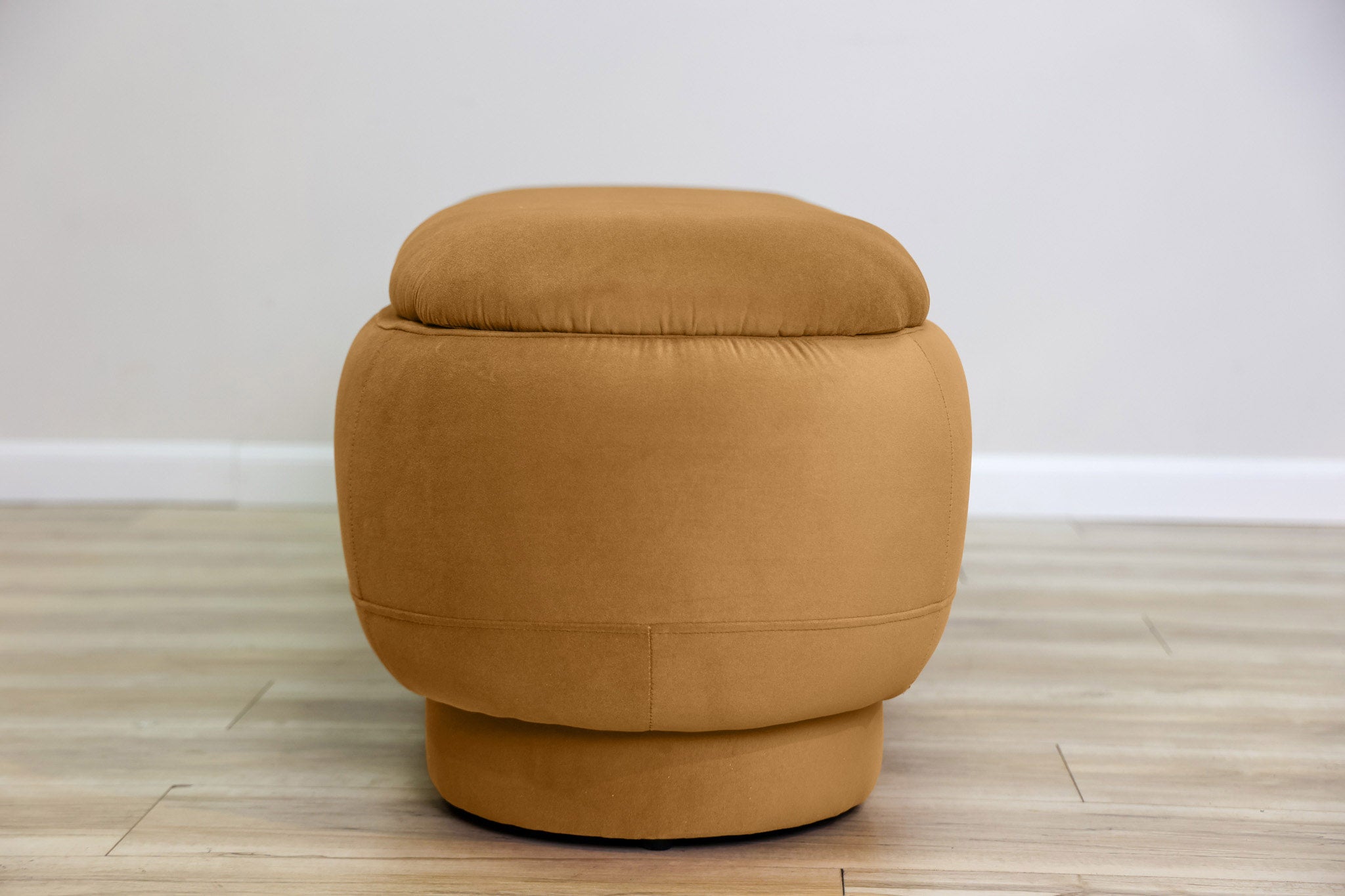 Dorian storage bench in golden velvet with a lift-top lid open to hidden storage and rounded drum feet, living room