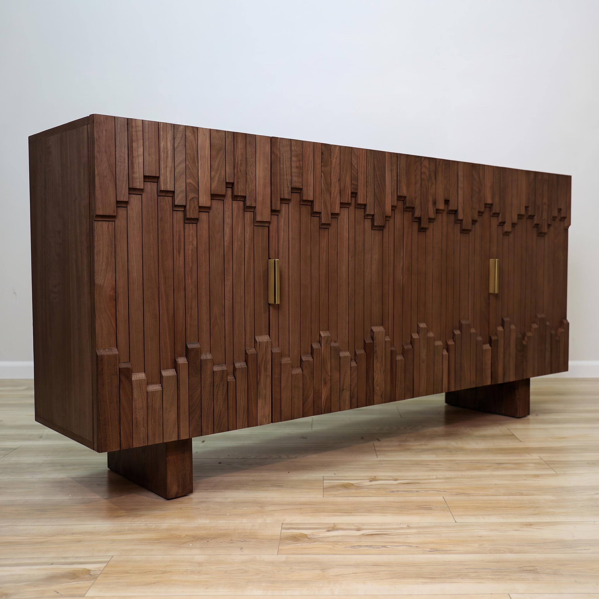 Mary credenza in solid mango wood with a sculptural block-relief front, gold bar pulls, and block feet, living room