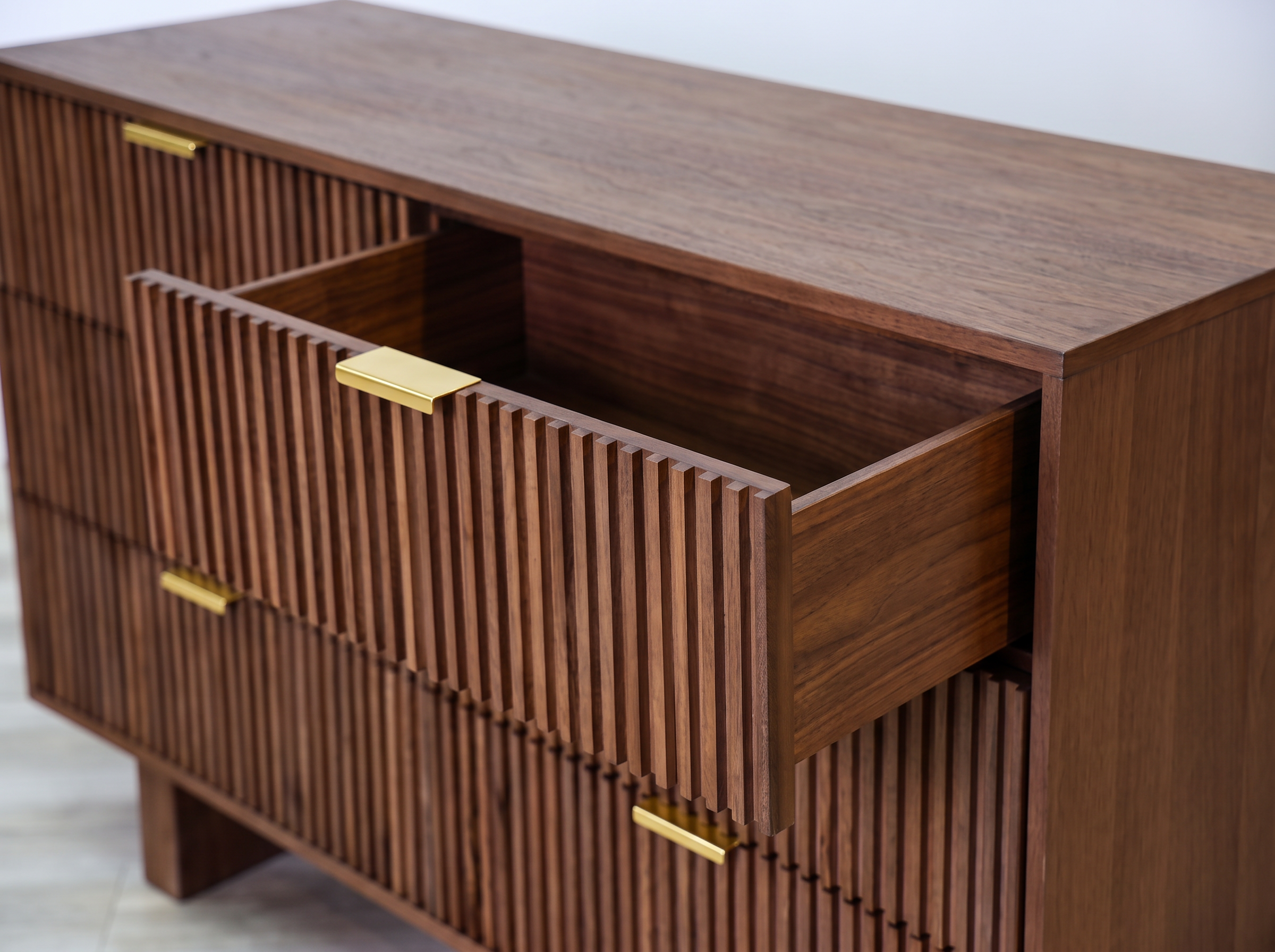 Mocha dresser in solid mango wood with six fluted drawer fronts, gold bar pulls, and two solid block feet, bedroom