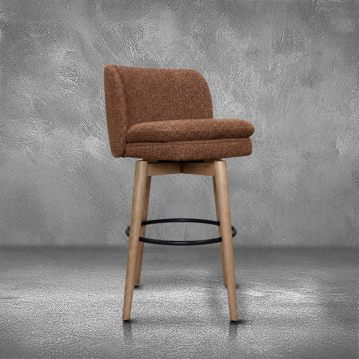 Elmer barstool in rust performance fabric with a low wraparound back, natural wood legs, and a black ring footrest, kitchen bar