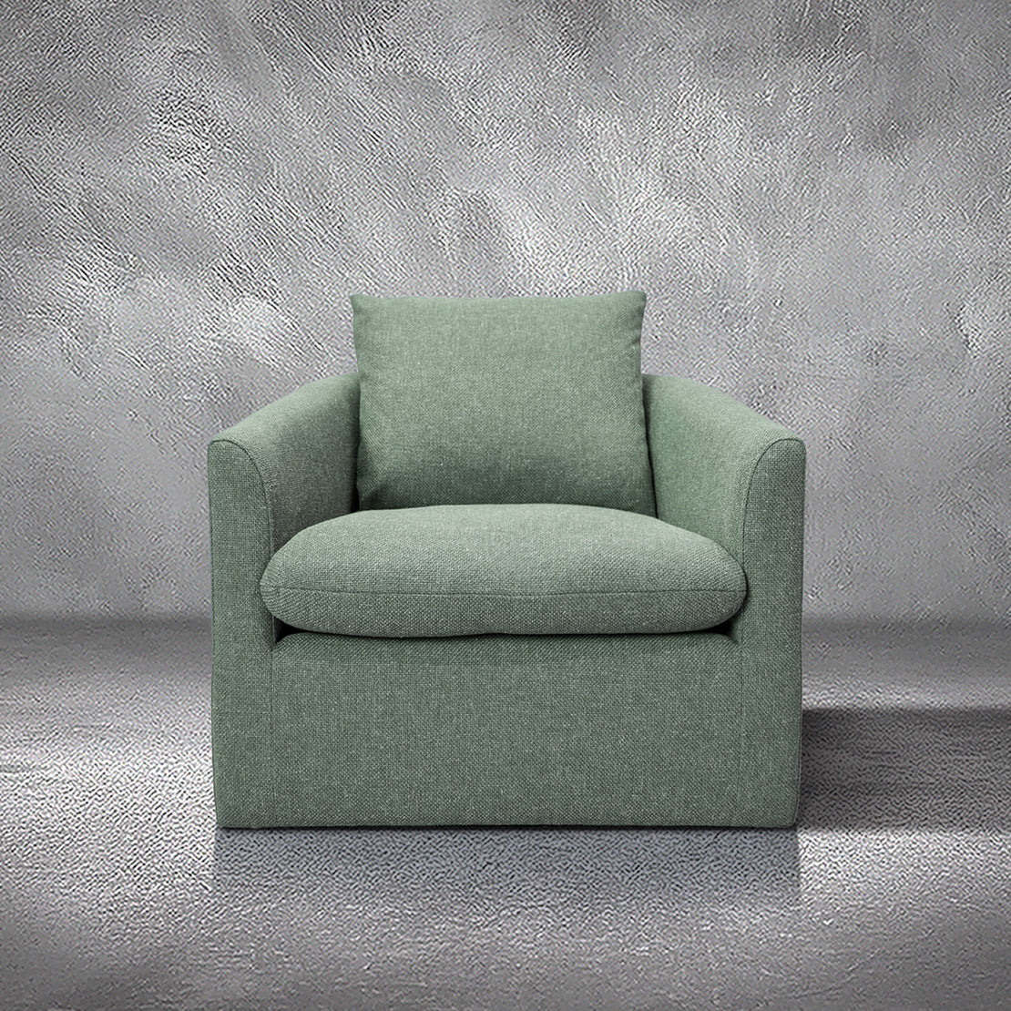 Halle green performance fabric swivel accent chair with a barrel silhouette, loose back pillow, and black swivel base