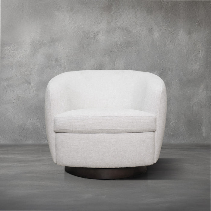 London Swivel Chair in white performance fabric with a curved barrel body on a dark wood swivel base, living room