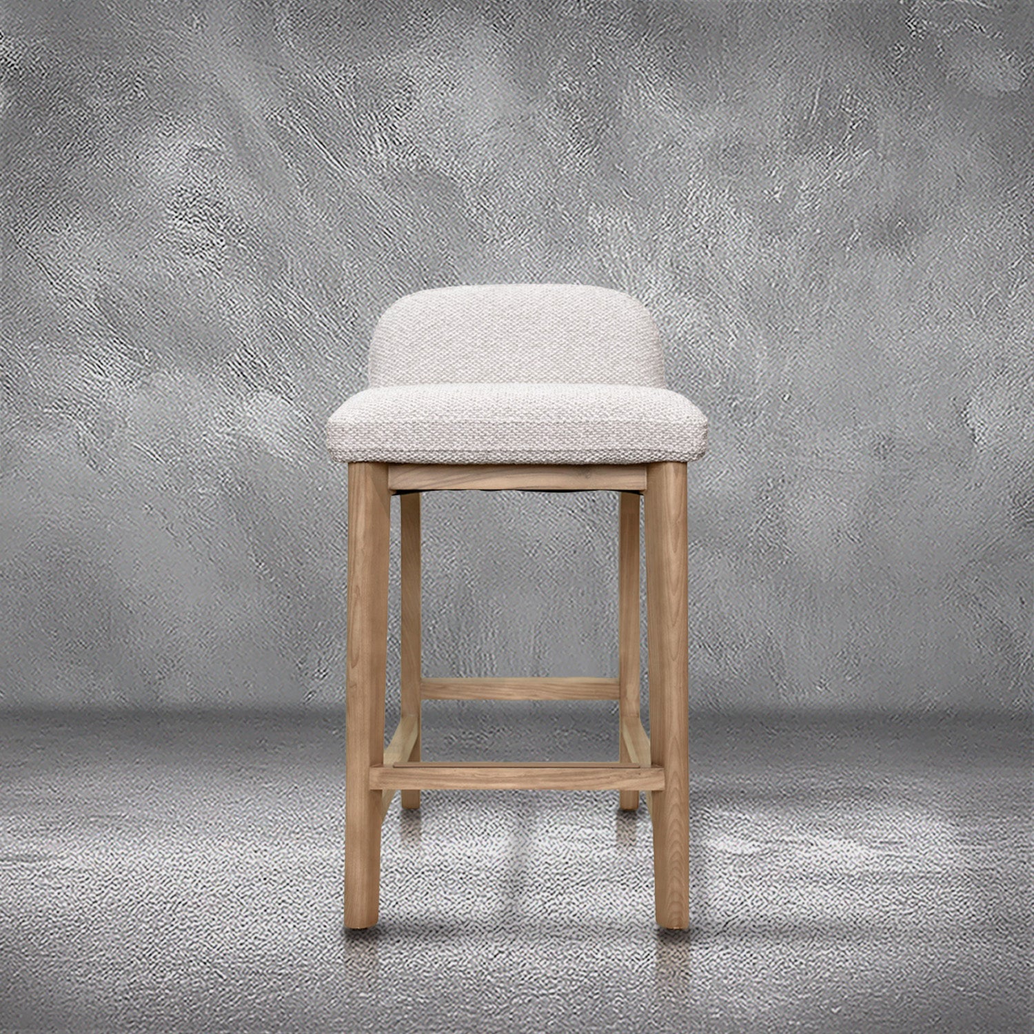 Asher counter stool in beige performance fabric with a low back and natural wood legs with stretchers, kitchen counter