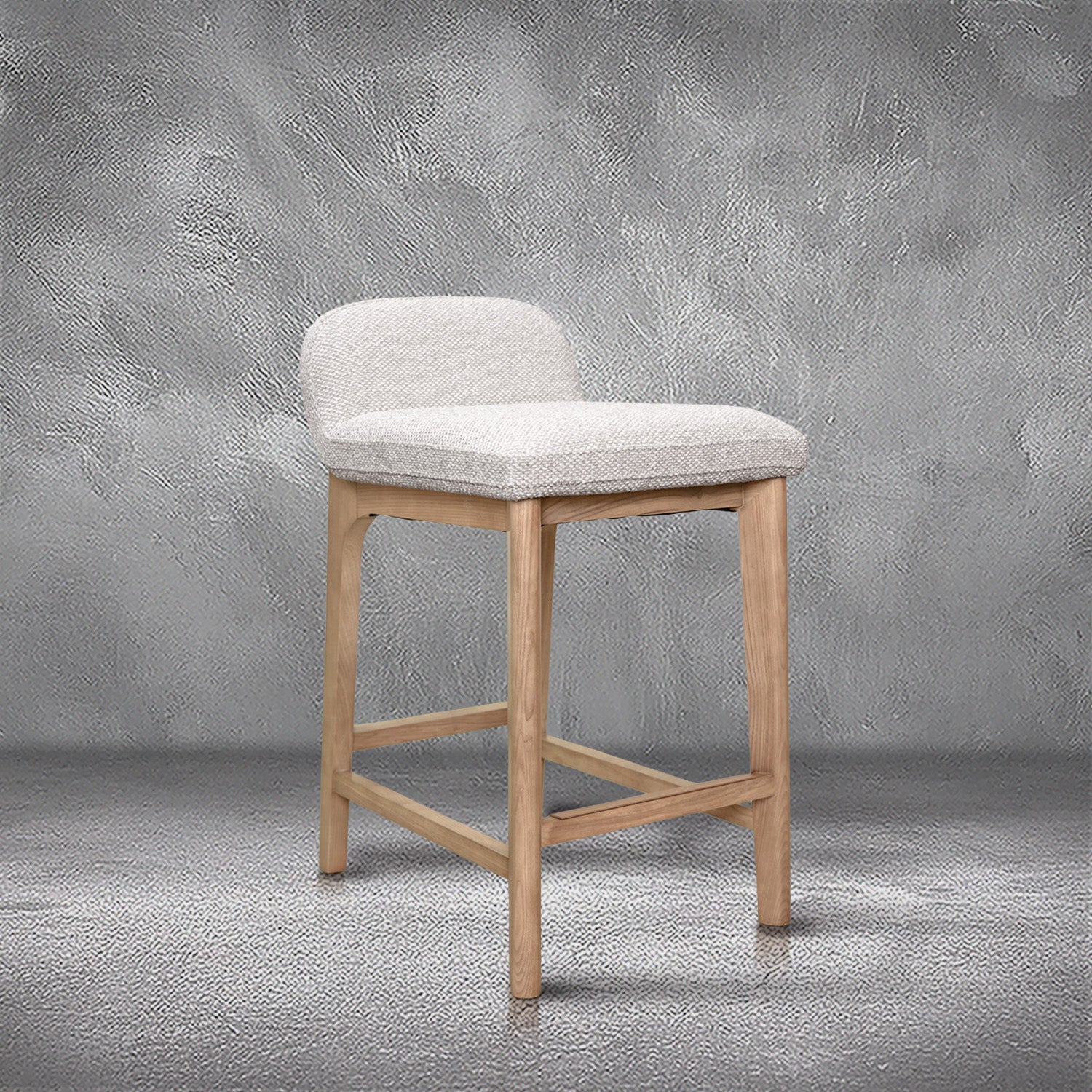 Asher counter stool in beige performance fabric with a low back and natural wood legs with stretchers, kitchen counter