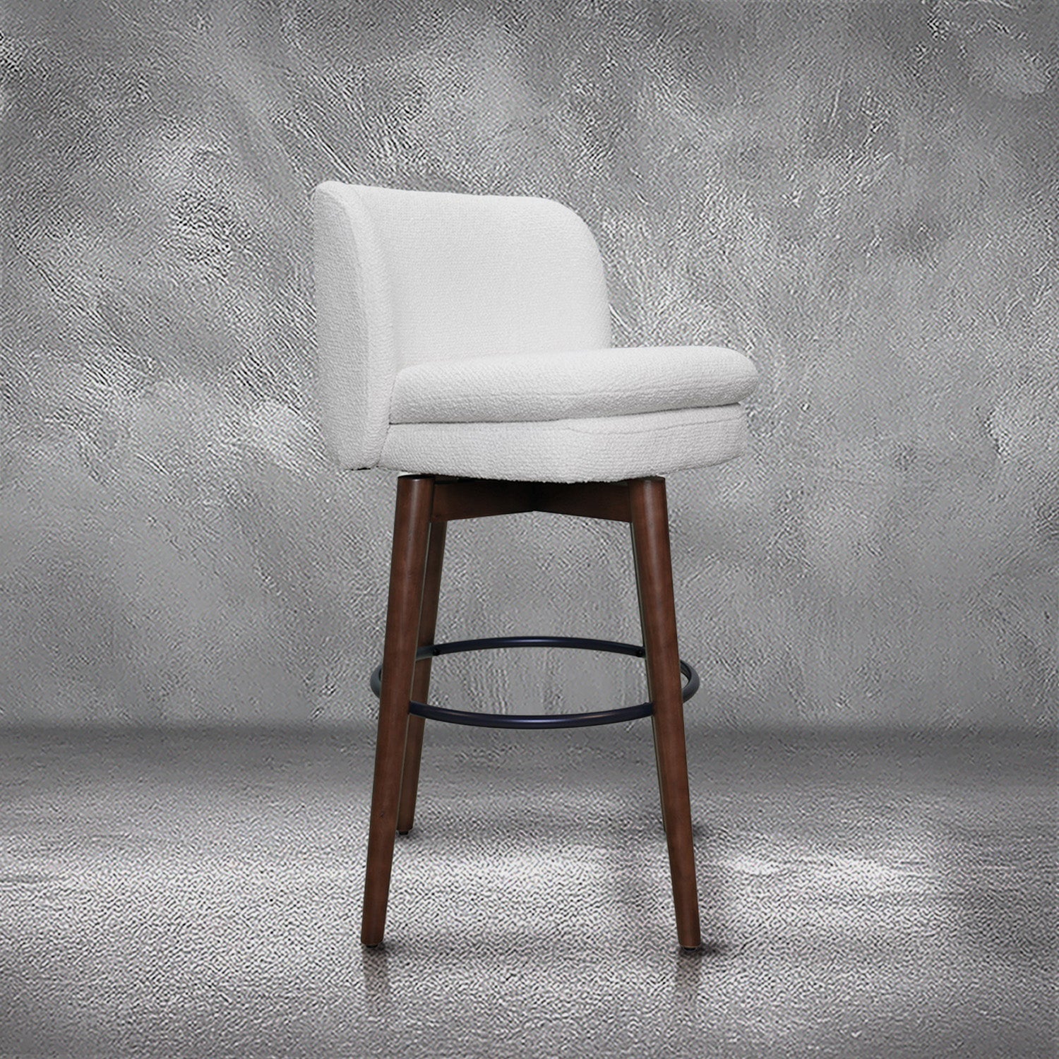 Avalon swivel barstool in cream bouclé performance fabric with walnut wood legs and a black ring footrest, kitchen bar