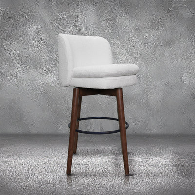 Avalon swivel barstool in cream bouclé performance fabric with walnut wood legs and a black ring footrest, kitchen bar