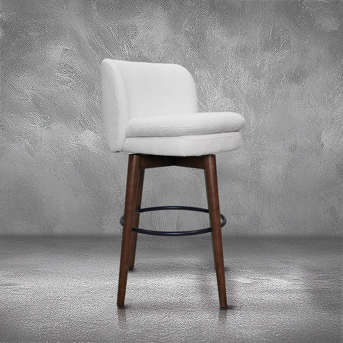 Avalon swivel barstool in cream bouclé performance fabric with walnut wood legs and a black ring footrest, kitchen bar