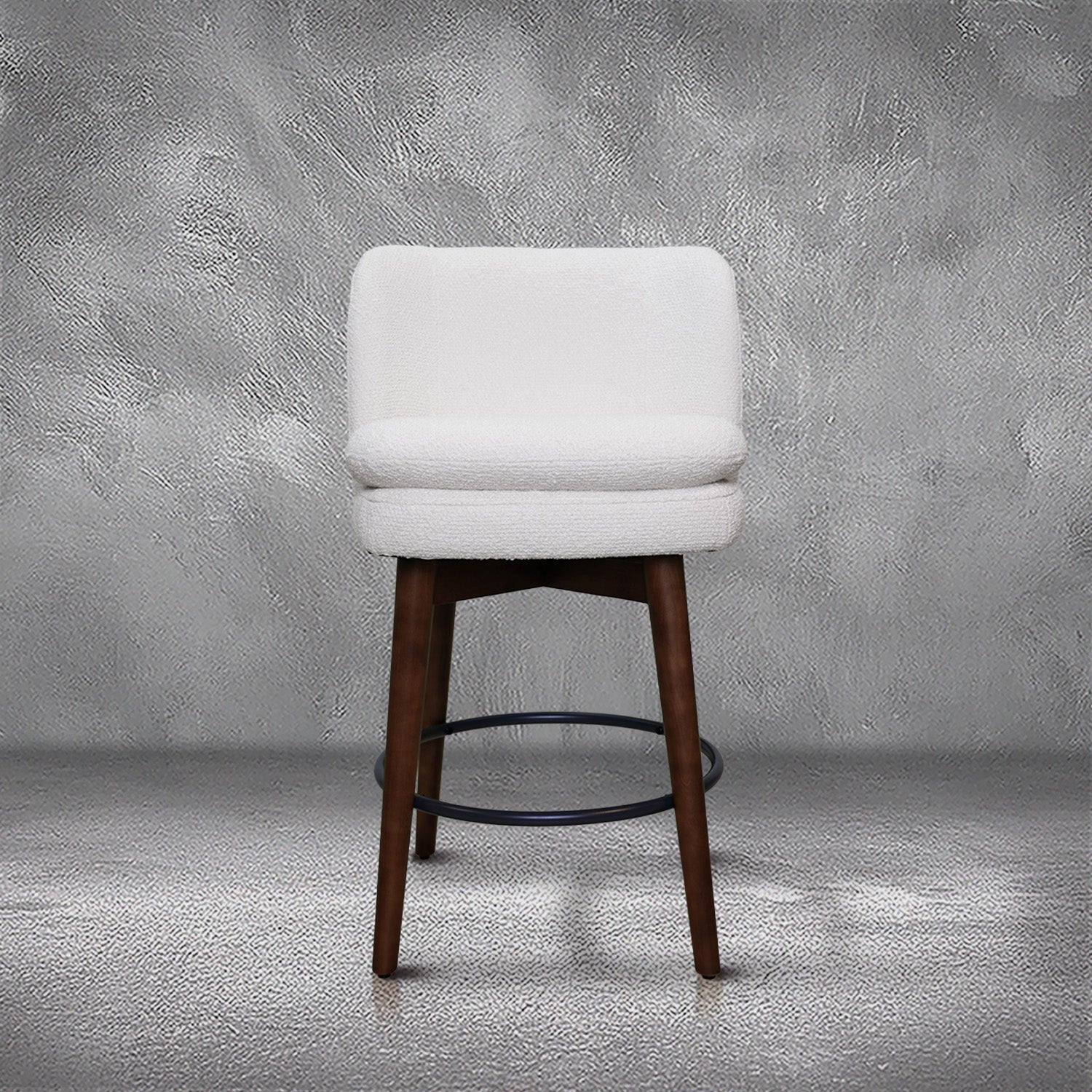 Avalon swivel counter stool in cream bouclé performance fabric with walnut wood legs and a black ring footrest, kitchen counter