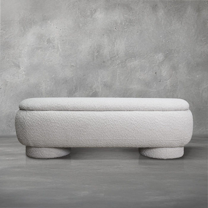 Casper storage bench in creamy white bouclé with a lift-top lid and rounded drum feet, living room