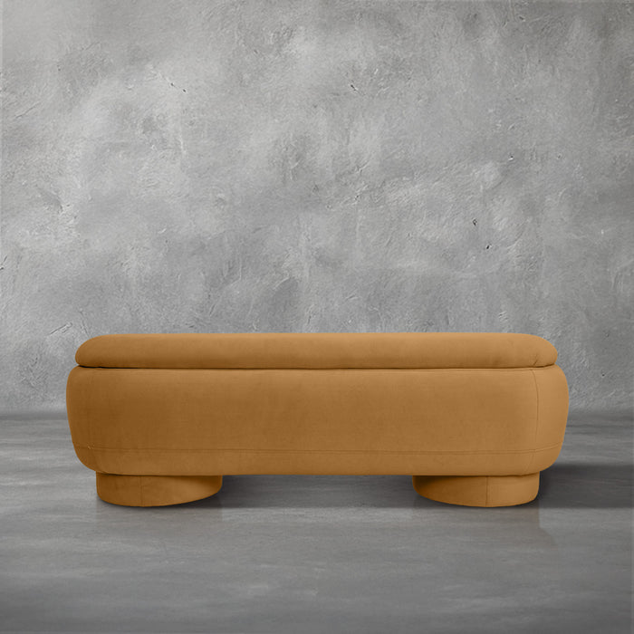 Dorian storage bench in golden velvet with a lift-top lid open to hidden storage and rounded drum feet, living room