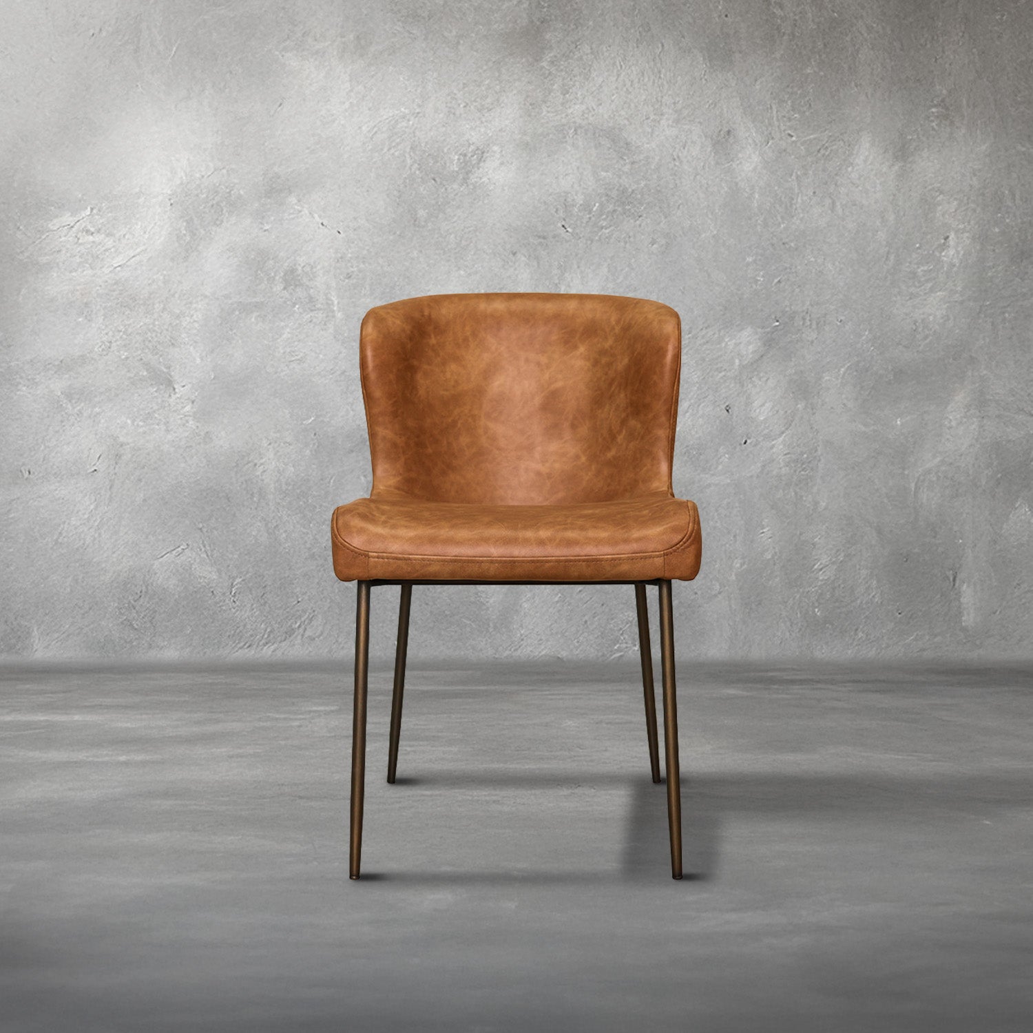 Easley dining chair in cognac brown faux leather with a curved wingback and slim bronze metal legs, dining room