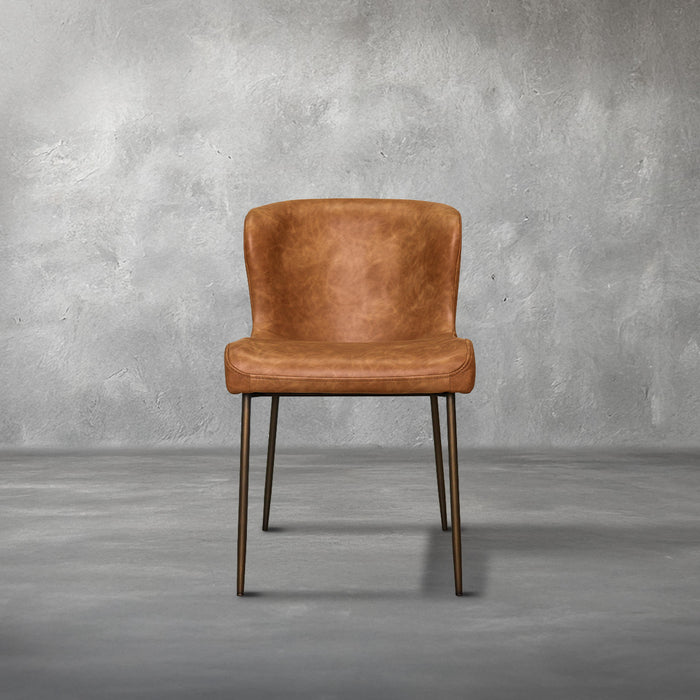 Easley dining chair in cognac brown faux leather with a curved wingback and slim bronze metal legs, dining room
