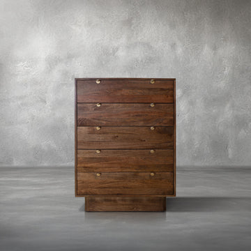 Harper Chest, tall walnut mango wood five-drawer chest with gold half-moon pulls, in a bedroom