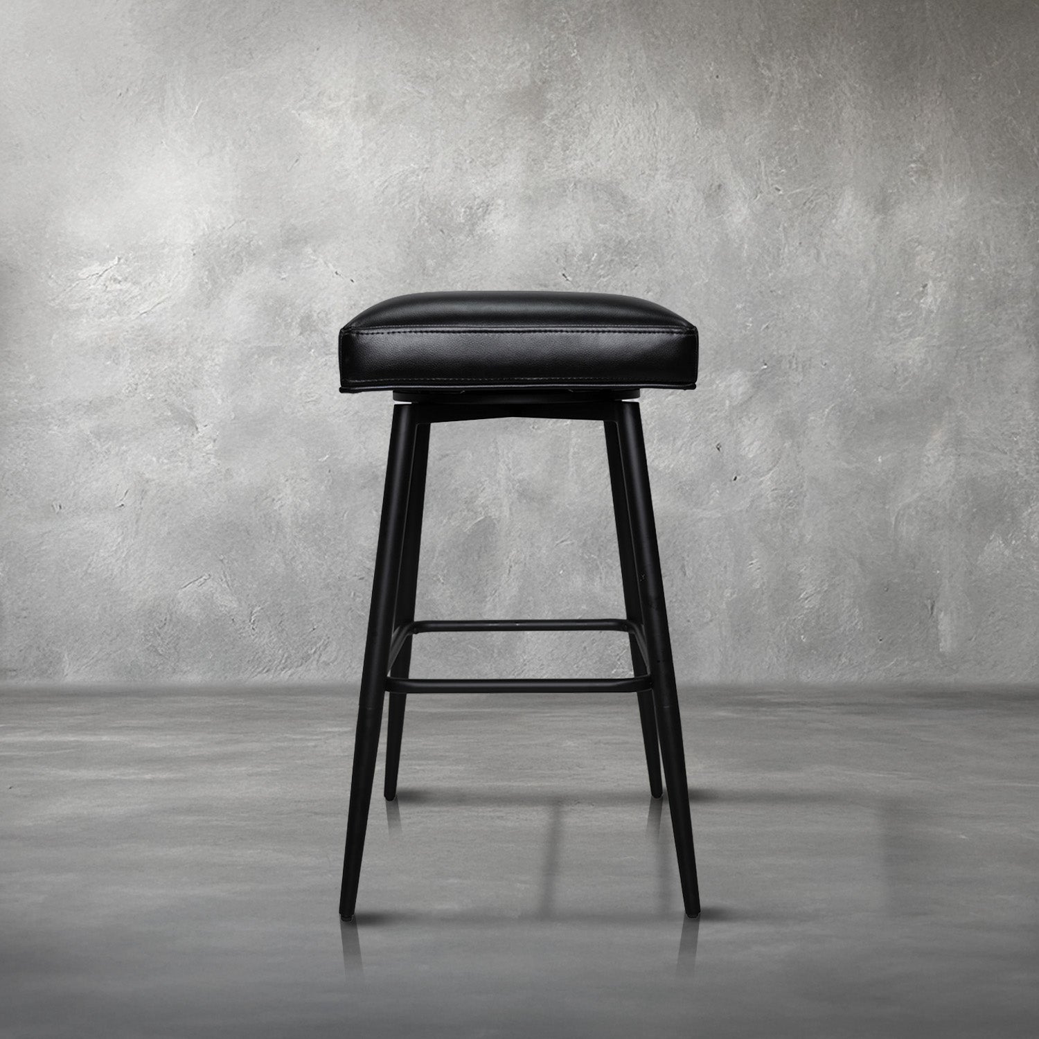 Versa backless adjustable stool in black faux leather with a black metal swivel base and footrest, kitchen bar