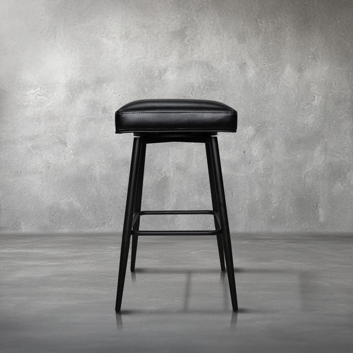 Versa backless adjustable stool in black faux leather with a black metal swivel base and footrest, kitchen bar