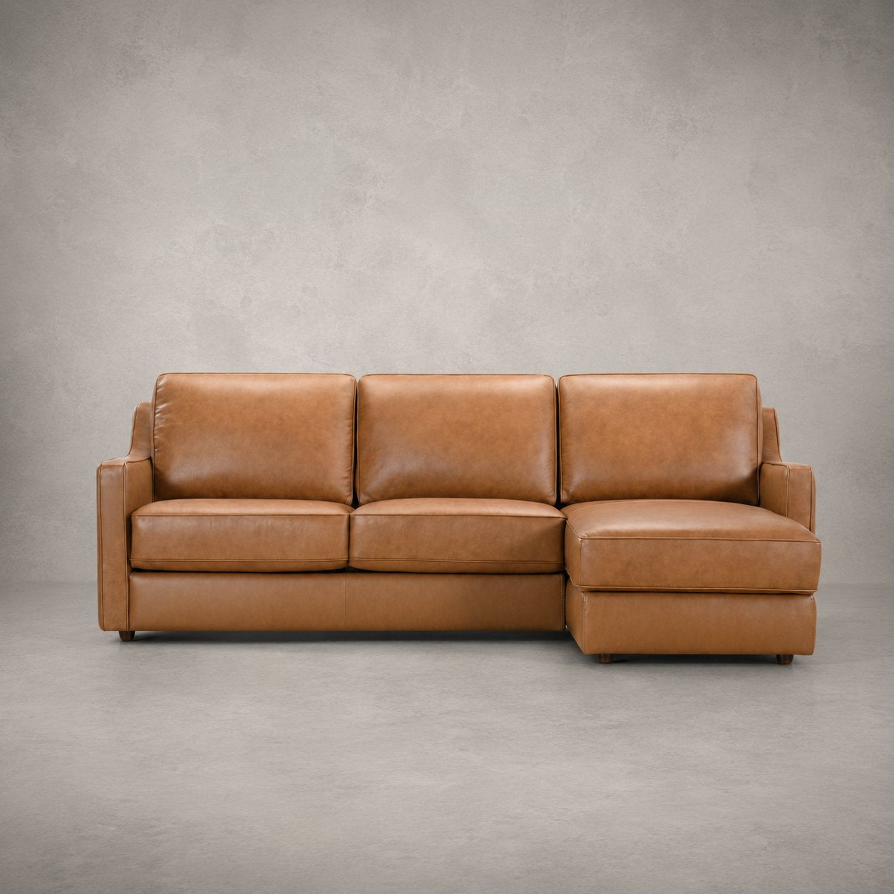 Johnson Sectional in camel leather, studio front view
