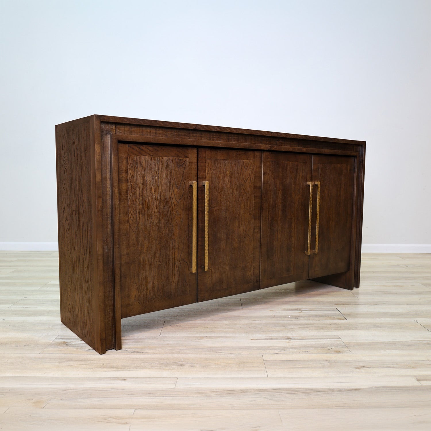 Manny 67-inch credenza in solid Mexican pine with four doors and hammered gold bar handles, living room
