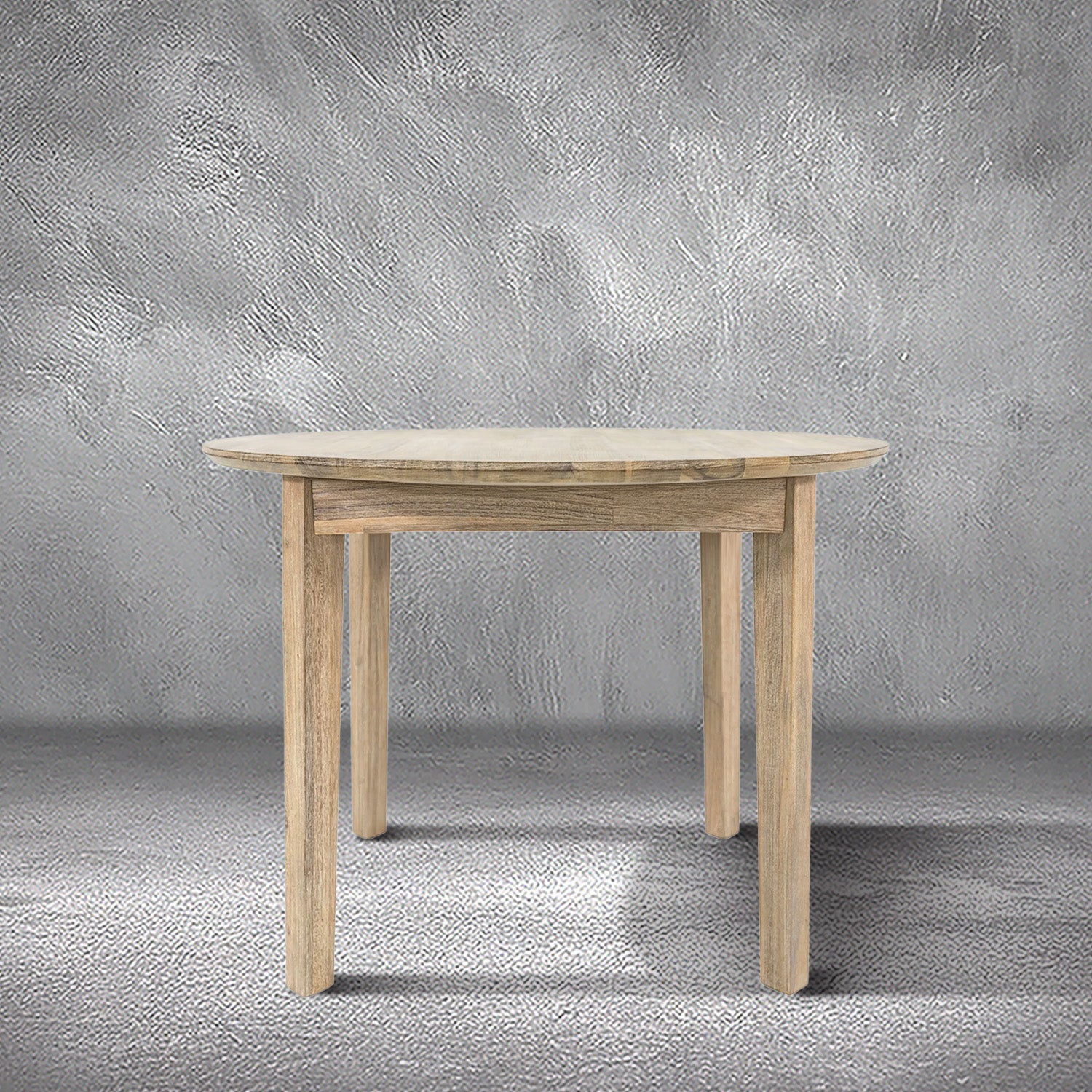 Reunion round dining table in light acacia wood with a round top and tapered legs, dining room