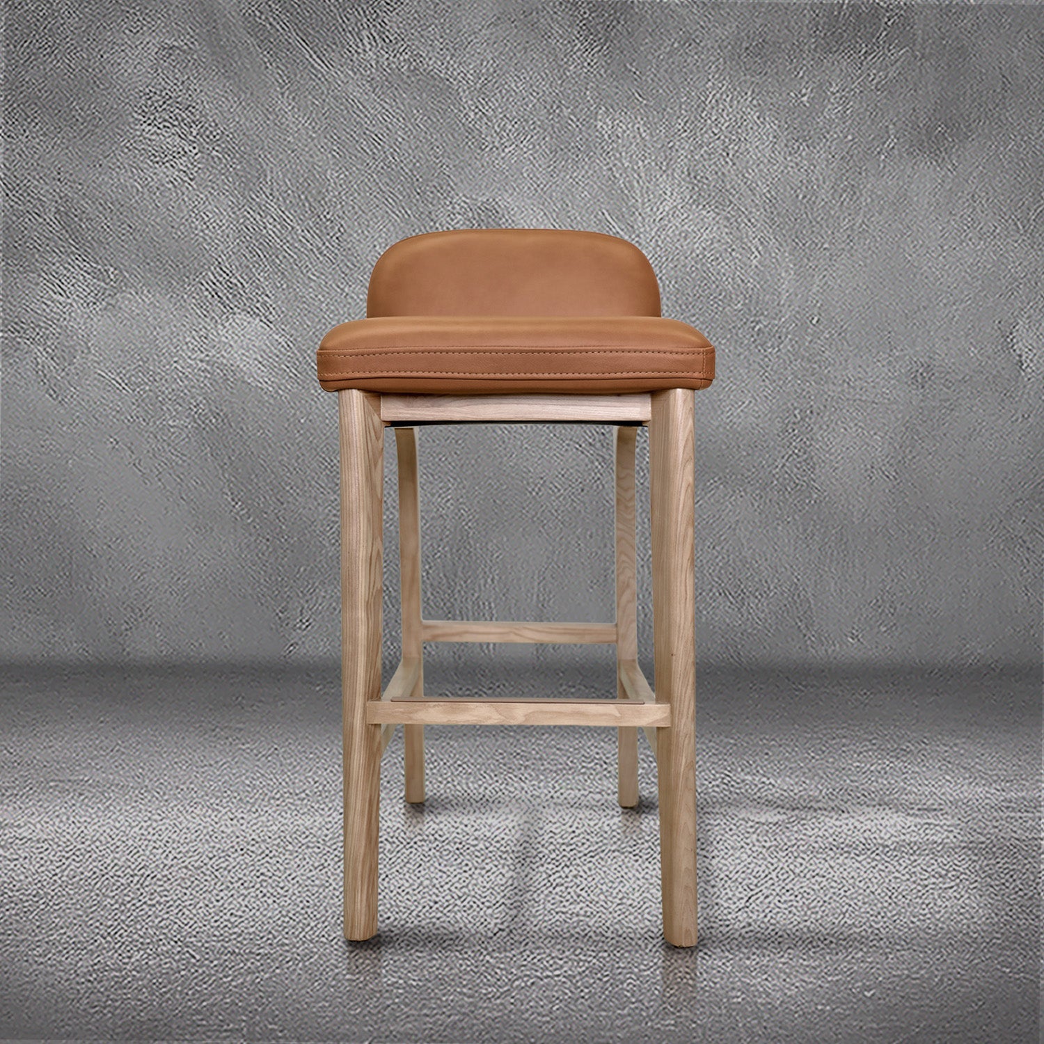 Sable barstool in cognac leather with a low back and natural wood legs with stretchers, kitchen bar