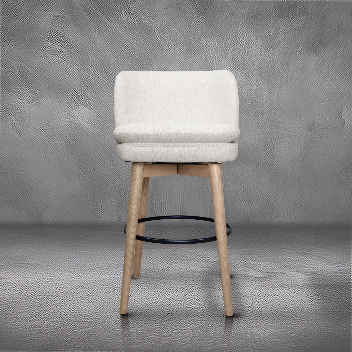 Tiffany swivel barstool in ivory Crypton fabric with natural wood legs and a black ring footrest, kitchen bar