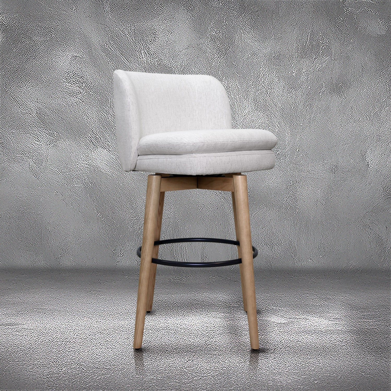 Tiffany swivel barstool in ivory Crypton fabric with natural wood legs and a black ring footrest, kitchen bar