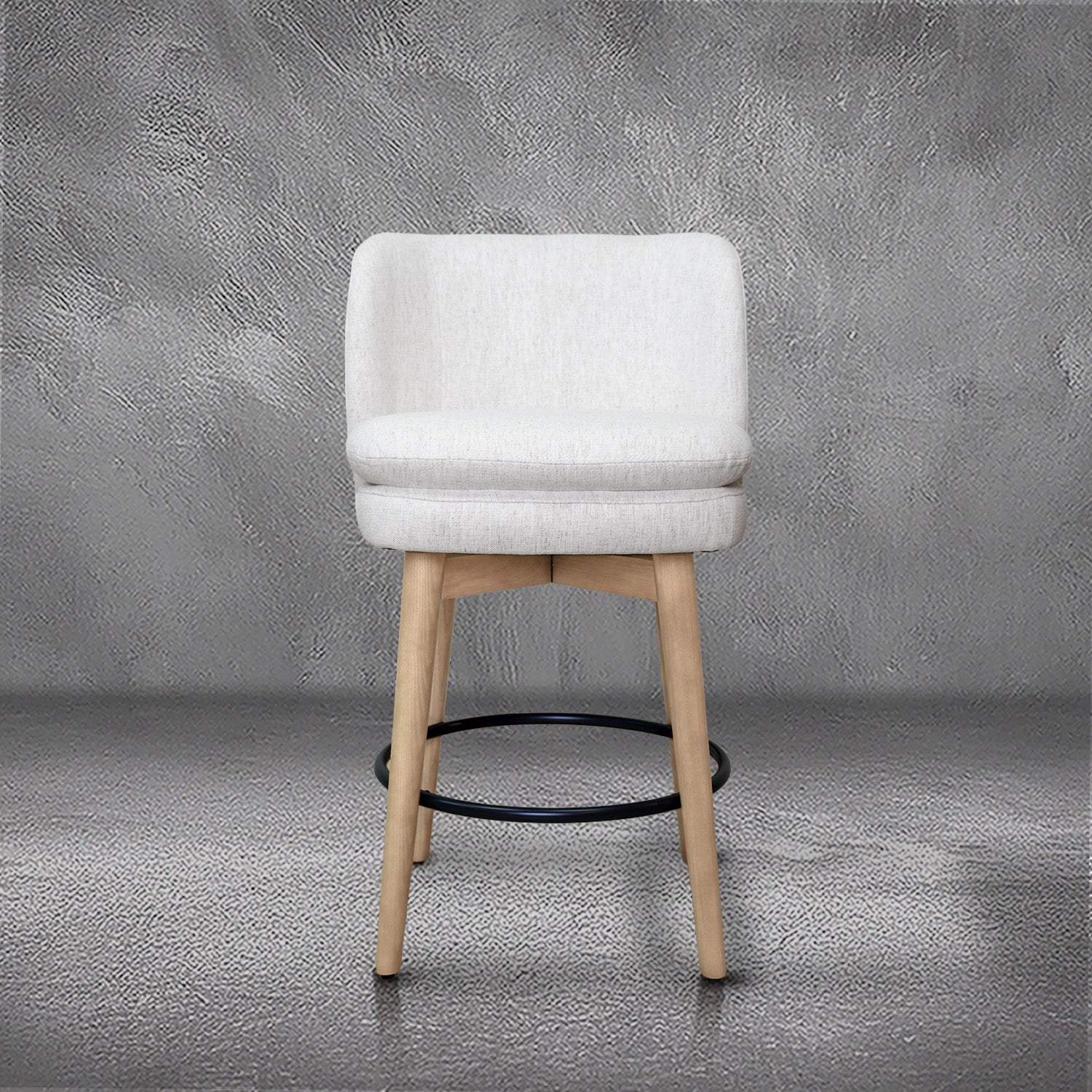 Tiffany swivel counter stool in ivory Crypton fabric with natural wood legs and a black ring footrest, kitchen counter